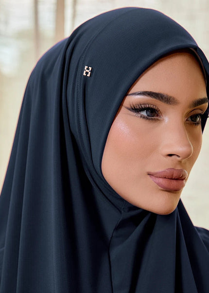 Woman wearing a dark hijab with a blurred background