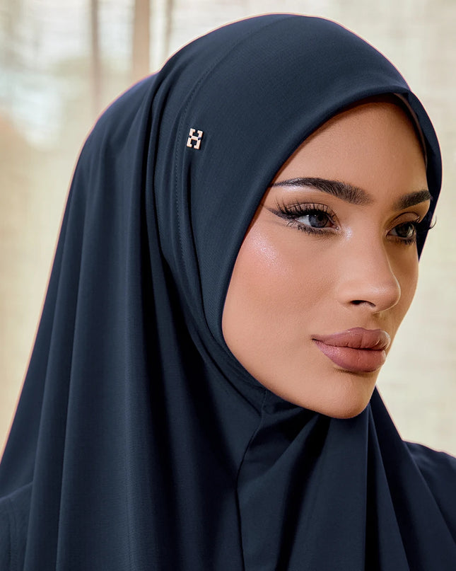 Woman wearing a dark hijab with a blurred background