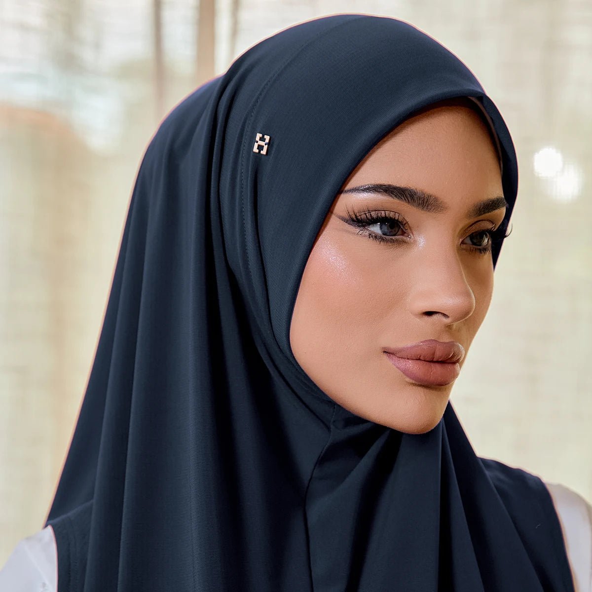Woman wearing a dark hijab with a blurred background
